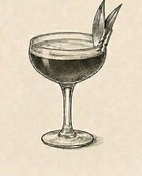 Pineapple and Smoke cocktail in a coupe glass with pineapple leaves