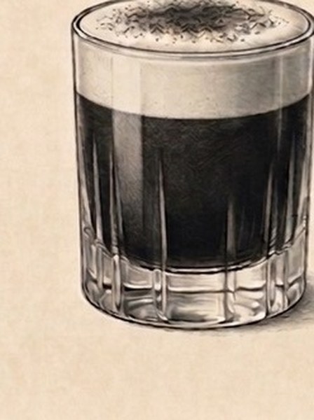 Tiramisu cocktail in a fluted glass with latte foam top and cocoa dusting